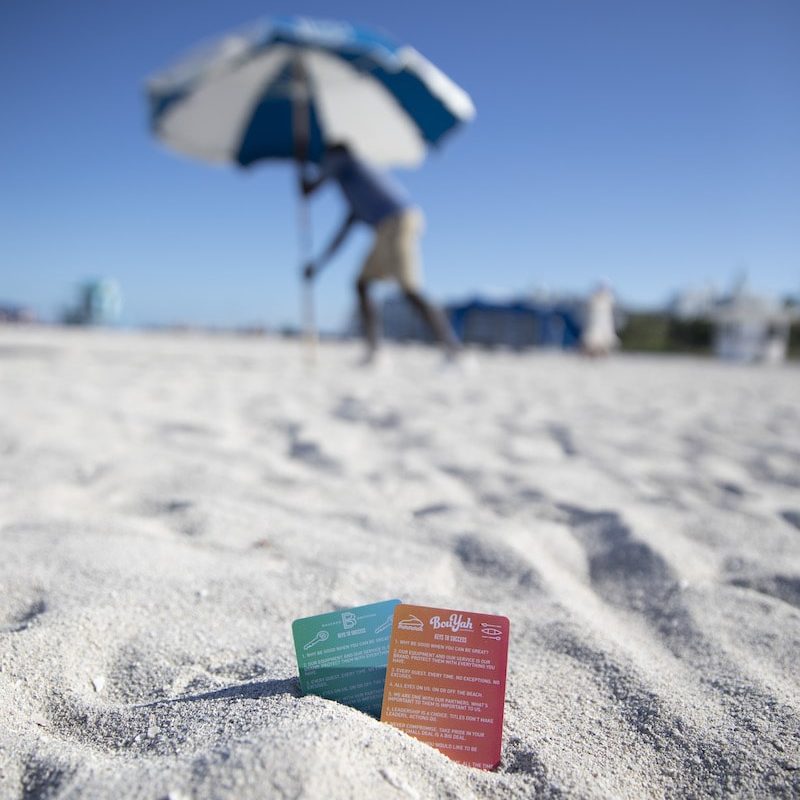 Event staff preparing a private beach setup.