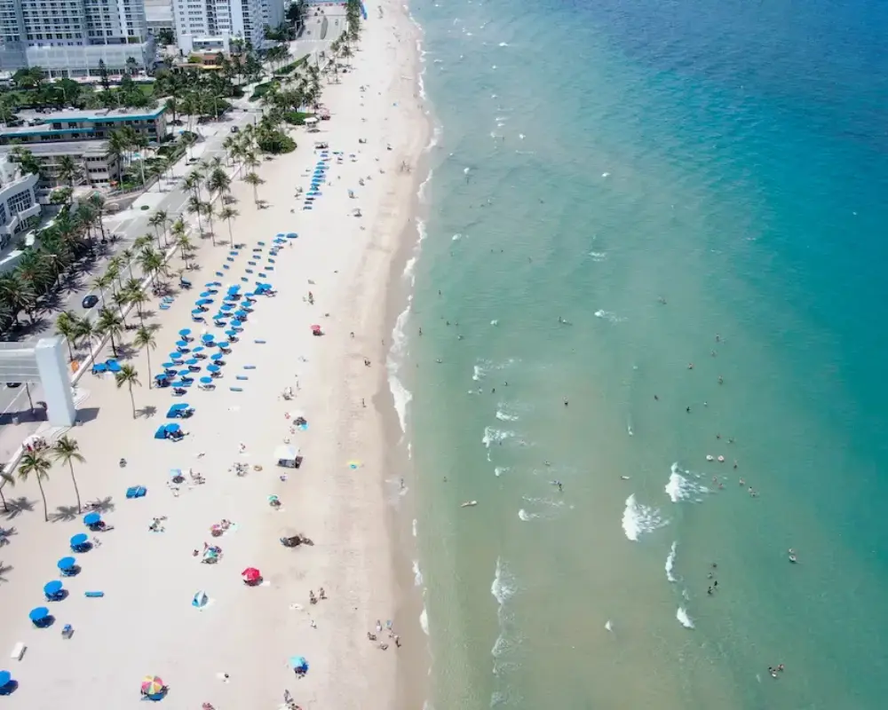 Drone view of Fort Lauderdale Beach meeting the city skyline.