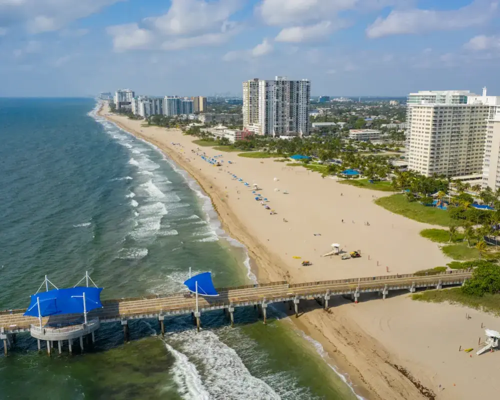 Aerial of Pompano Beach pier and coastline.